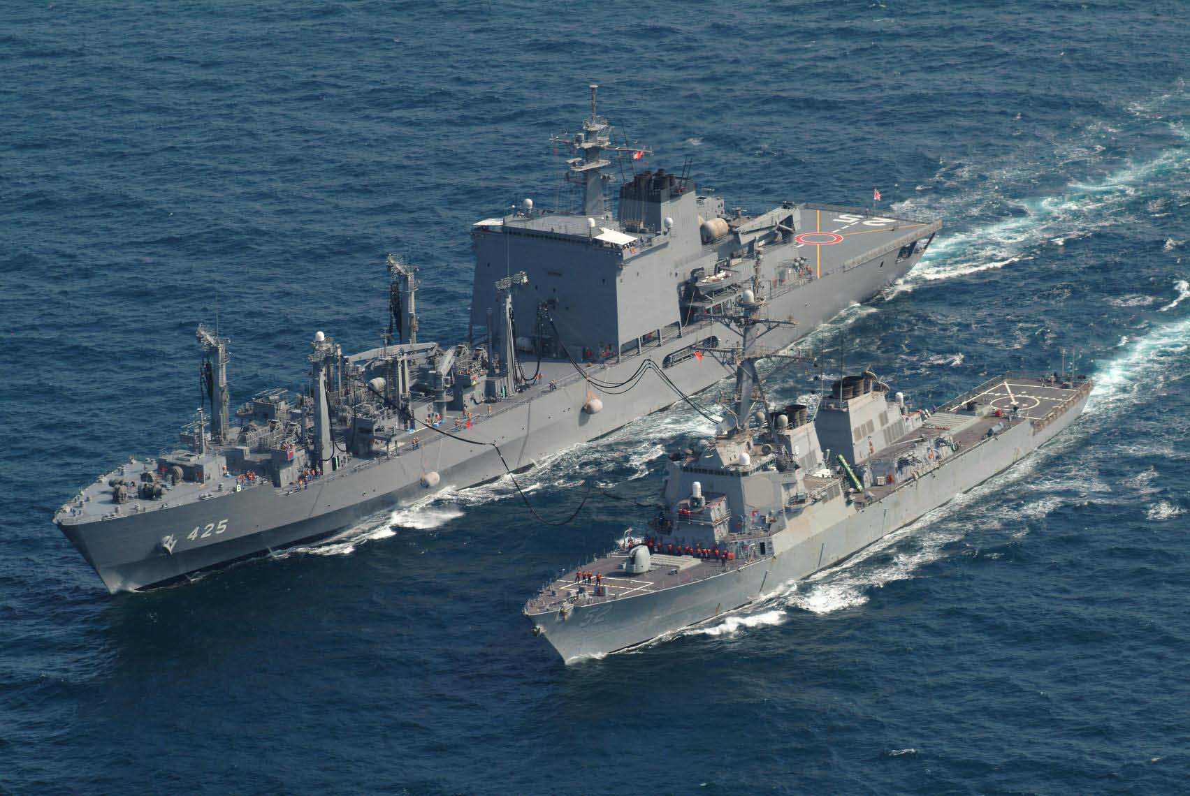 Japanese replenishment oiler refueling another warship