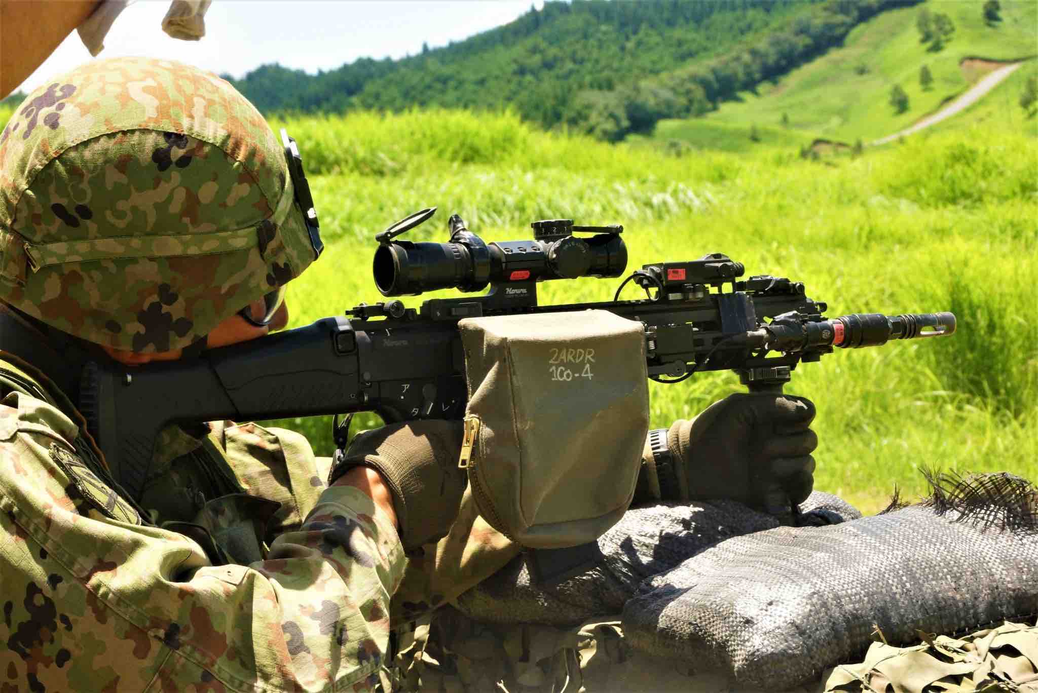 Japanese soldier firing a Type 20 rifle