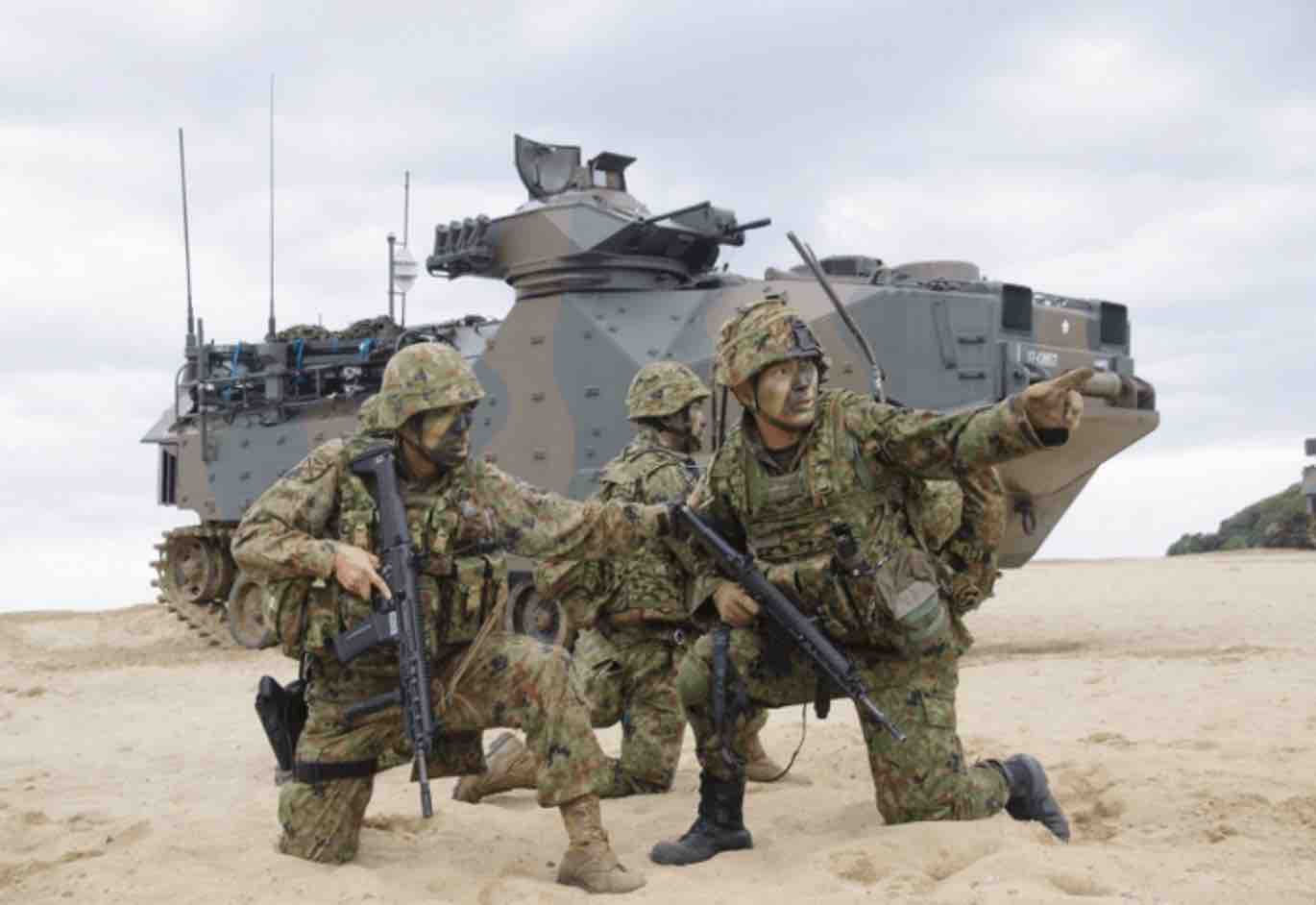 soldiers and amphibious vehicles landing on a beach