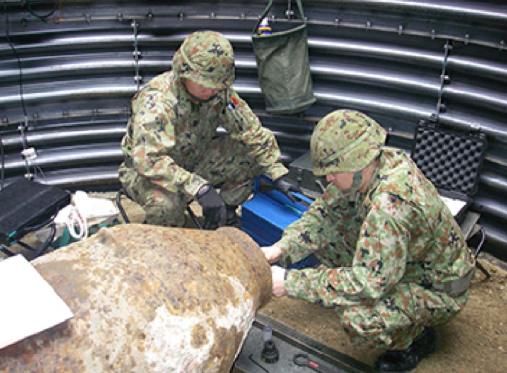 soldiers defusing an unexploded ordnance